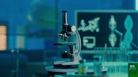 Microscope, glass test tubes and flasks on the background of a computer monitor Stock Footage 234275598