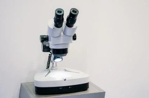 Microscope in a laboratory on a white background. Fotos Stock