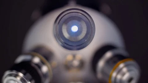 The microscope lens approaches the subject desk to achieve the desired sharpness Stock Footage 82722673