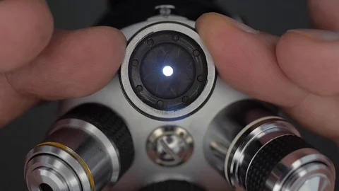 On the microscope lens, manually close (open) the diaphragm to correct exposure  Stock Footage 82722732