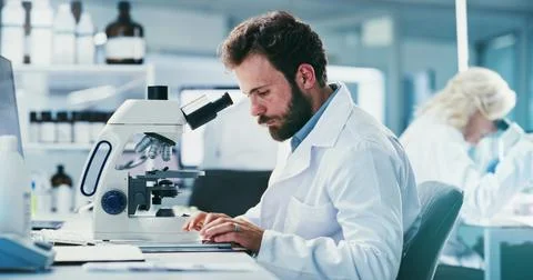 Microscope, man and scientist in laboratory for pharmaceutical research, st.. Stock Photos