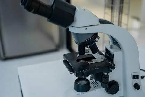 Microscope is placed on a lab table in a modern laboratory setting during d.. Stock Photos