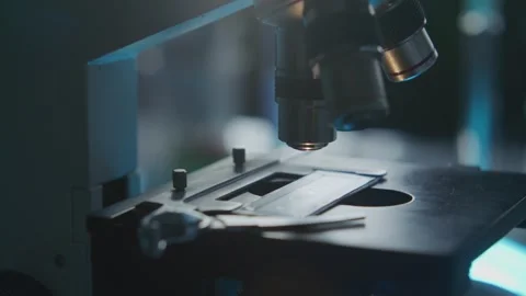 Microscope Research in a Dark Laboratory Setting 库存影片 331110611