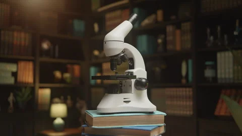 A microscope rotating slowly at the library on a stack of books, HQ 4K footage Stock Footage 273167267