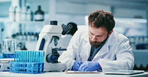 Microscope, science and writing with man in laboratory for development or r.. Stock Photos
