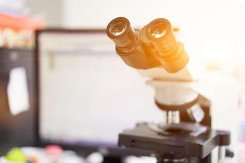 Microscope in a science lab to find something special. Stock Photos