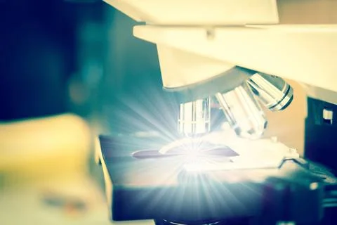 Microscope is shining special thing in science lab. Stock Photos