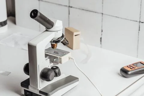 Microscope symbolizing the precision and careful analysis required in scientific Stock Photos