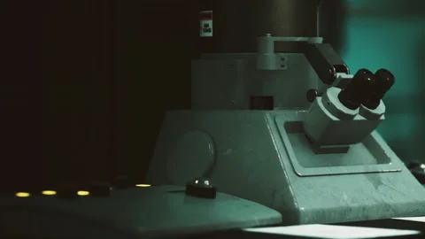 Microscope on a table in a dimly lit laboratory setting Stock Footage 342038339