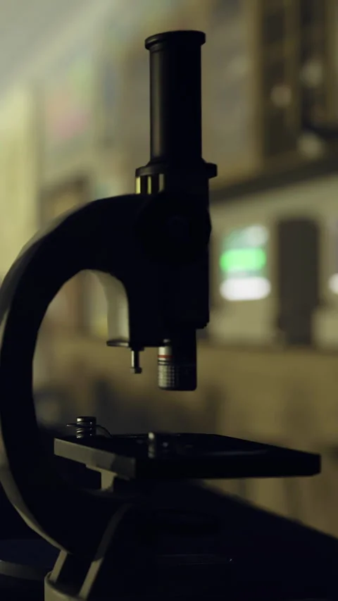 Microscope on table in laboratory with blurred background details Stock Footage 334173570