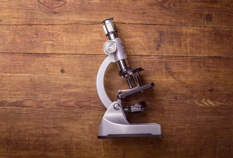 Microscope on table for vintage science background Stock Photos