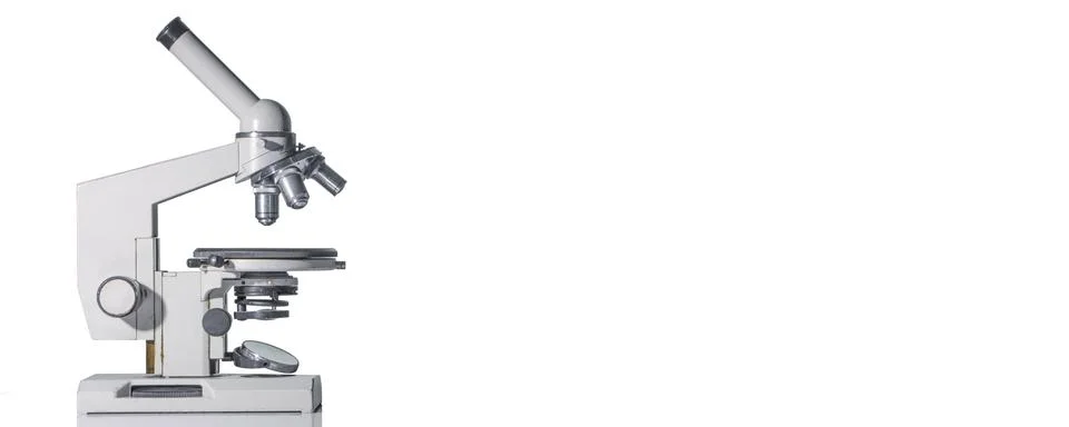 A microscope with three lenses on a white background. Stock Photos