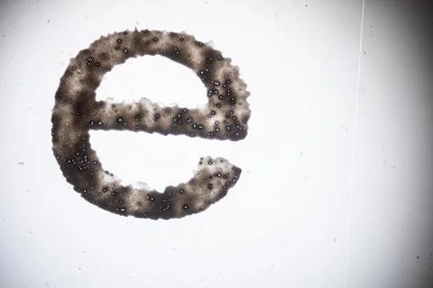 Microscope view of a dark porous sample shaped like. Stock Photos