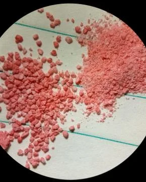 Microscope view of a pink powder material for pharmaceutics and cosmetics Stock Photos