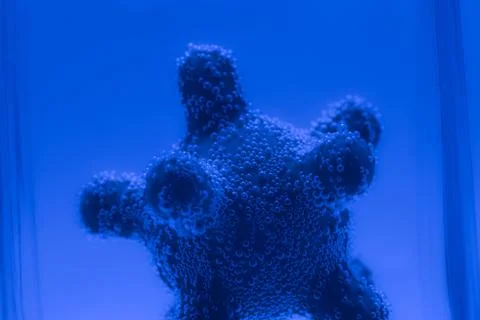 Microscope virus model in test tube close up Stock Photos