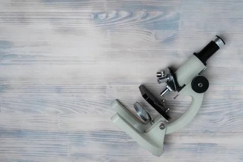 Microscope on white wooden background Stock Photos