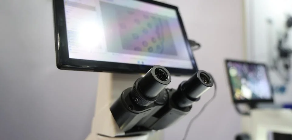 Microscopes and digital imaging systems analyzing samples in laboratory. Stock Photos
