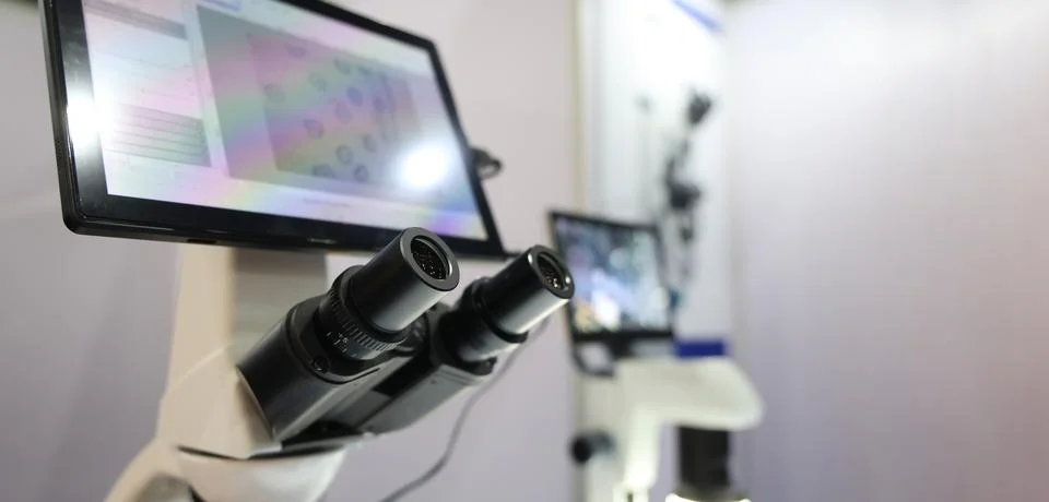 Microscopes and digital imaging systems analyzing samples in laboratory. Stock Photos