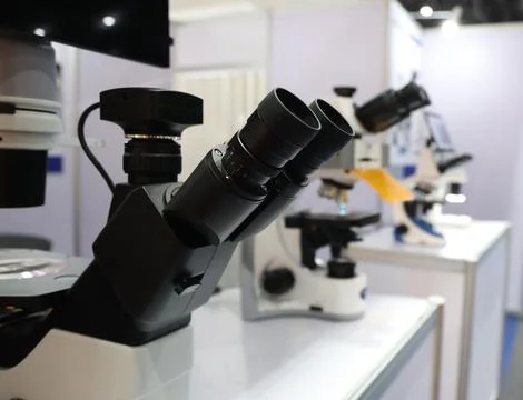 Microscopes and digital imaging systems analyzing samples in laboratory. Stock Photos