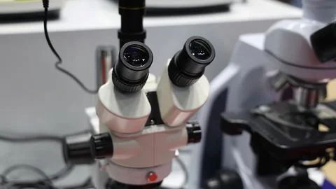Microscopes and digital imaging systems analyzing samples in laboratory. Stock Photos