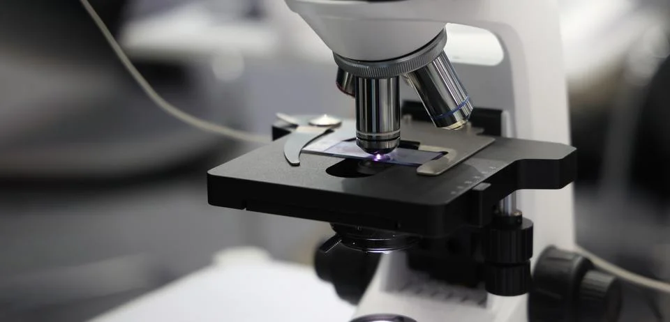 Microscopes and digital imaging systems analyzing samples in laboratory. Stock Photos