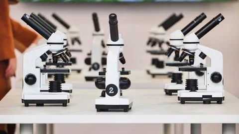 Microscopes lined up in a science laboratory classroom Stock Photos