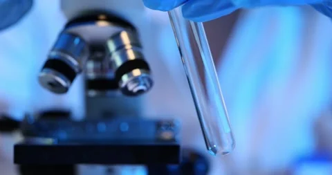 Microscopic analysis of a sample of a substance in test tubes in laboratory Stock Footage 271025825