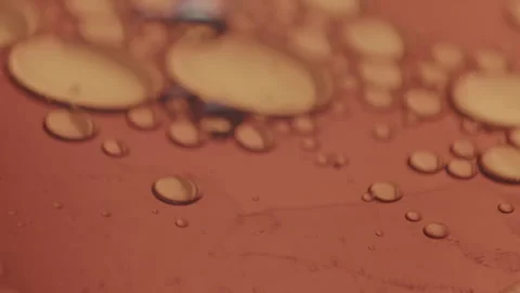 Microscopic bubbles moving in viscous amber liquid. Waves moving over the Stock Footage 144063972
