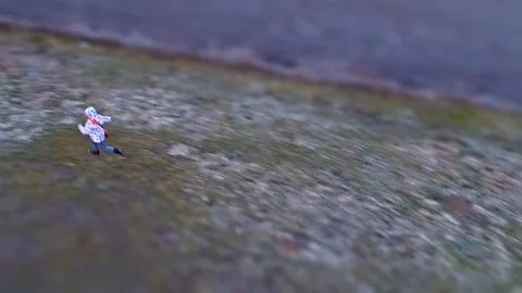 Microscopic child looking like a tiny insect. Drone footage with tilt-shift lens Stock Footage 122282448