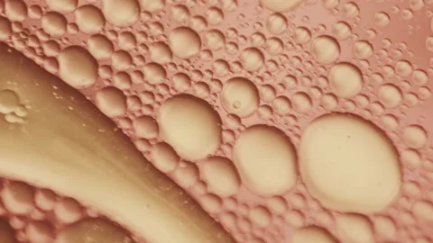 Microscopic particles swimming in amber liquid / scientific shot Video stock 143919626