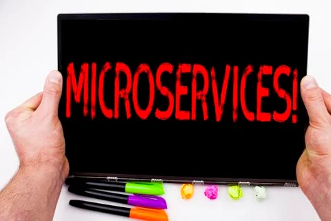 Microservices text written on tablet, computer in the office with marker, pen Stock Photos