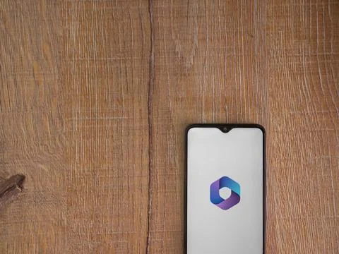 Microsoft 360 app launch screen on smartphone on wooden background Stock Photos