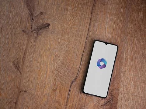 Microsoft 360 app launch screen on smartphone on wooden background Stock Photos