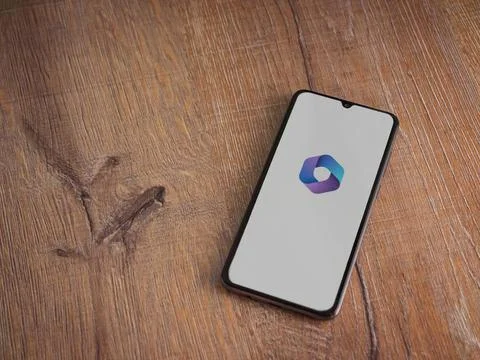 Microsoft 360 app launch screen on smartphone on wooden background Stock Photos
