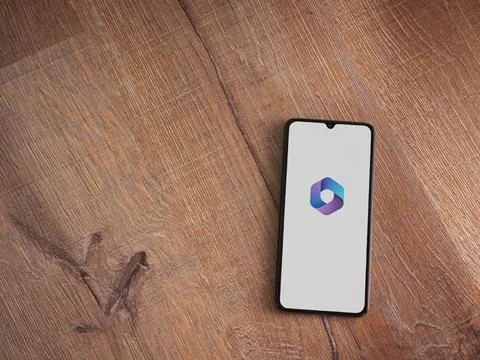 Microsoft 360 app launch screen on smartphone on wooden background Stock Photos
