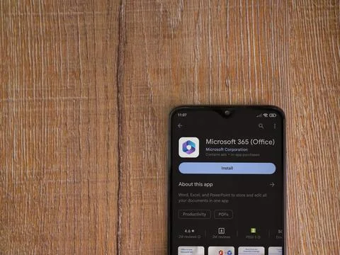 Microsoft 360 app play store page on smartphone on wooden background Stock Photos