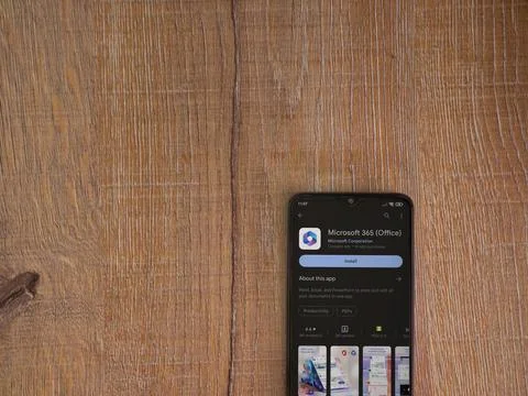Microsoft 360 app play store page on smartphone on wooden background Stock Photos