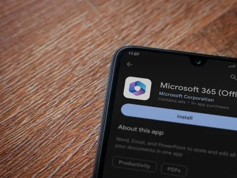 Microsoft 360 app play store page on smartphone on wooden background Stock Photos