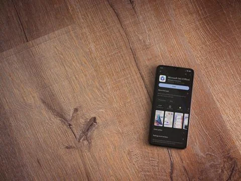 Microsoft 360 app play store page on smartphone on wooden background Stock Photos