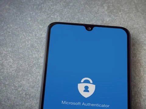 Microsoft Authenticator app launch screen with logo on the display of a black Stock Photos