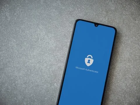 Microsoft Authenticator app launch screen with logo on the display of a black Stock Photos