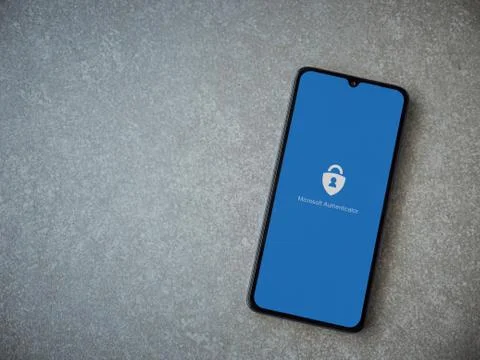 Microsoft Authenticator app launch screen with logo on the display of a black Stock Photos