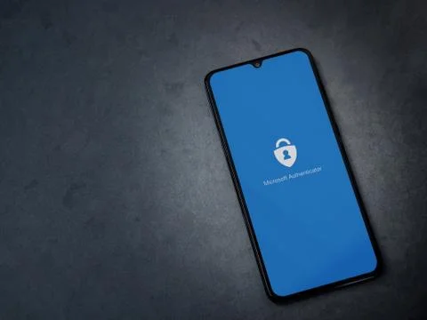 Microsoft Authenticator app launch screen with logo on the display of a black Stock Photos