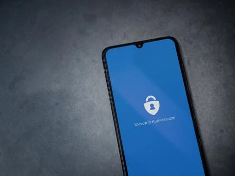Microsoft Authenticator app launch screen with logo on the display of a black Stock Photos