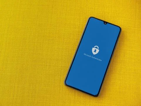 Microsoft Authenticator app launch screen with logo on the display of a black Stock Photos