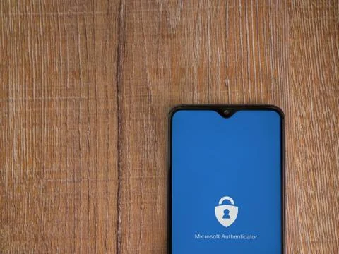 Microsoft Authenticator app launch screen with logo on the display of a black Stock Photos