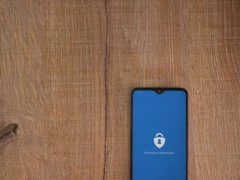 Microsoft Authenticator app launch screen with logo on the display of a black Stock Photos