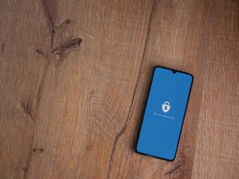 Microsoft Authenticator app launch screen with logo on the display of a black Stock Photos