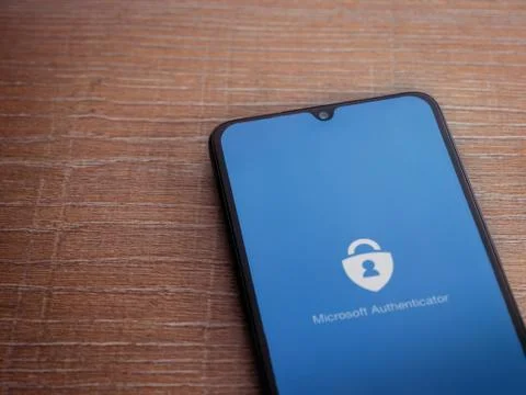 Microsoft Authenticator app launch screen with logo on the display of a black Stock Photos