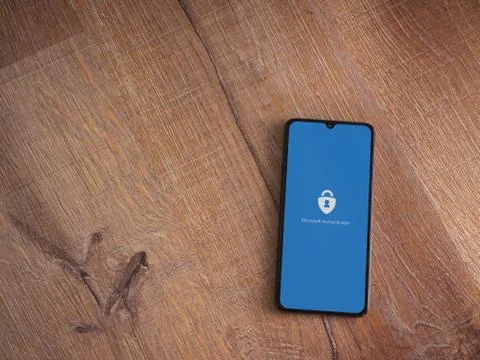 Microsoft Authenticator app launch screen with logo on the display of a black Stock Photos